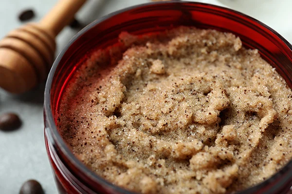 a red bowl with a brown sugar scrub
