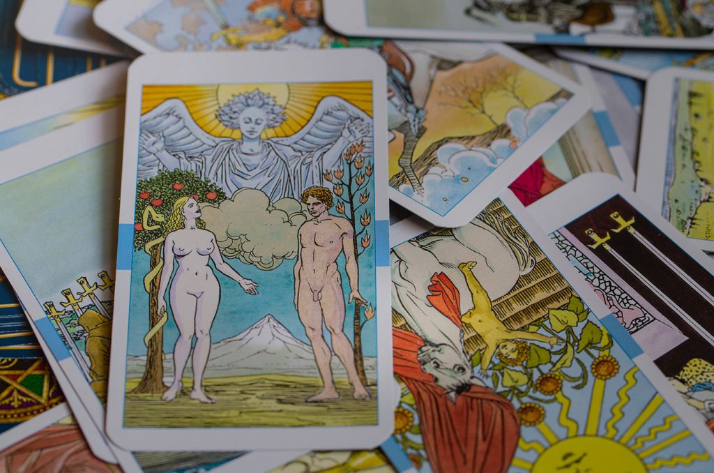 assorted tarot cards scattered in a pile